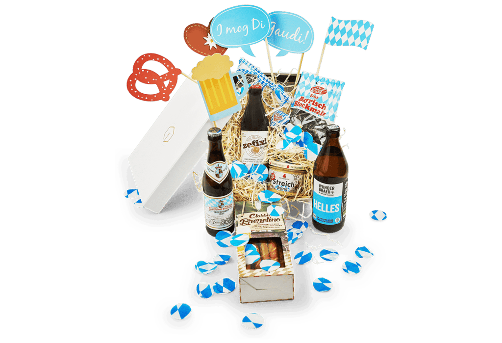 The Oktoberfest Box brings the Oktoberfest to your home! It contains a Helles from Wunderbraeu, a Tegernseer Hell, the unique brew lemonade zefix! from Bavaria, Bavarian block malt, Brezelinos, delicious spread made from onions and caraway seeds, blue and white party glasses and themed Oktoberfest photo props. The filler is mixed with blue and white confetti.